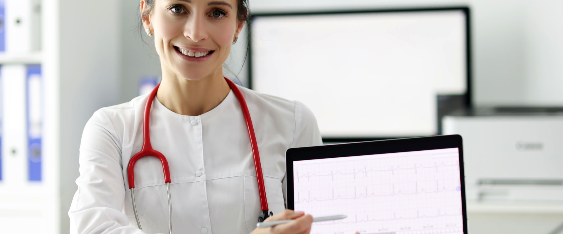 Doctor cardiologist showing electrocardiogram on digital tablet